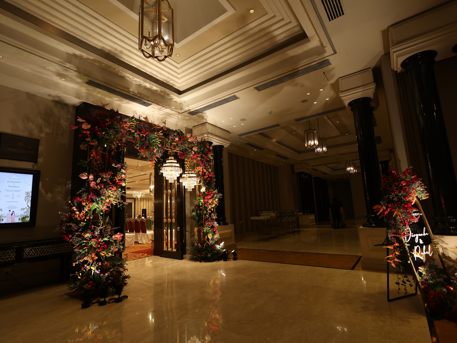 A lush, garden-inspired stage décor featuring a rich mix of vibrant florals and layered greenery