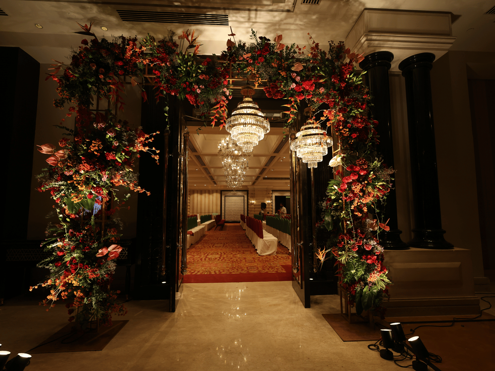 Enchanted garden event with botanical arches and hanging lights