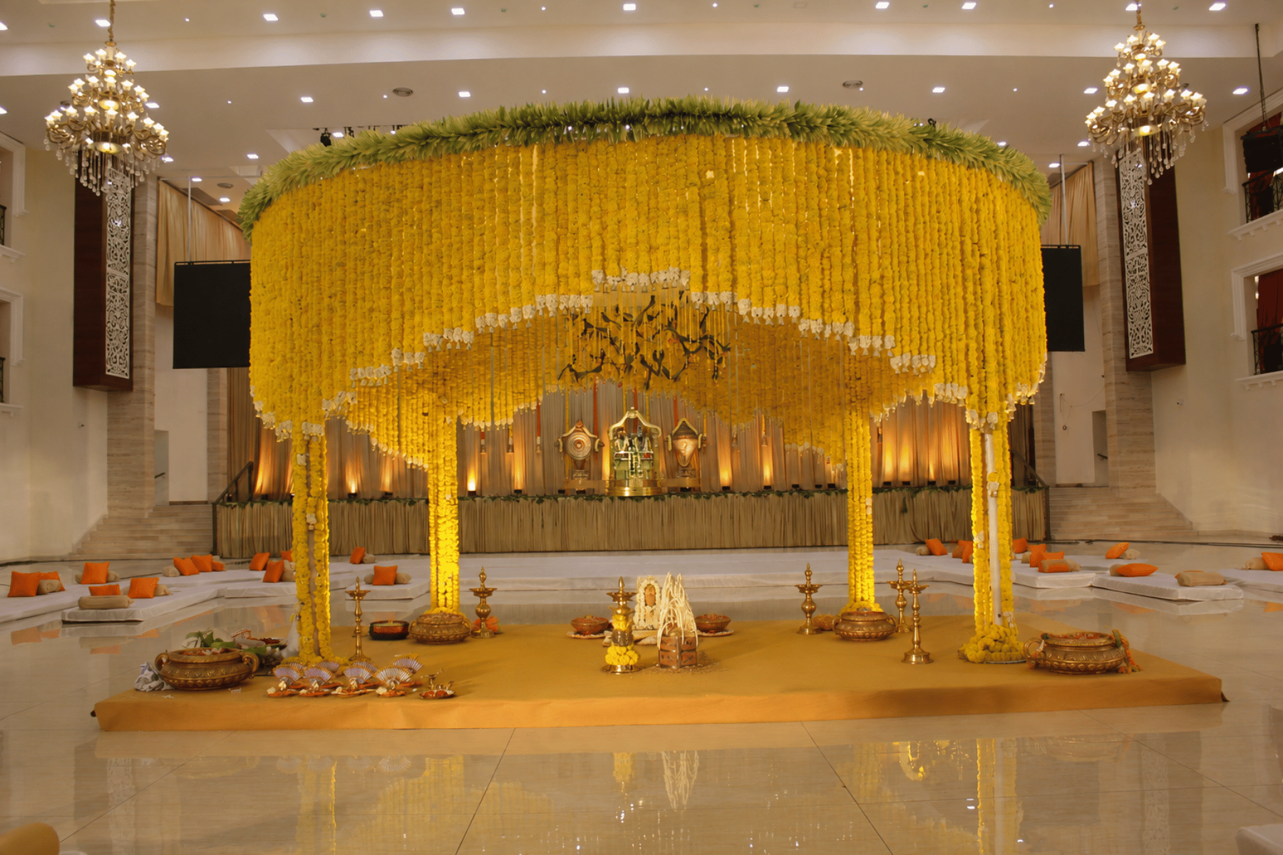 Ivory floral wedding mandap prepared inside a heritage venue
